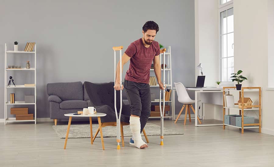 A man with a fractured leg doing rehabilitation at home​
