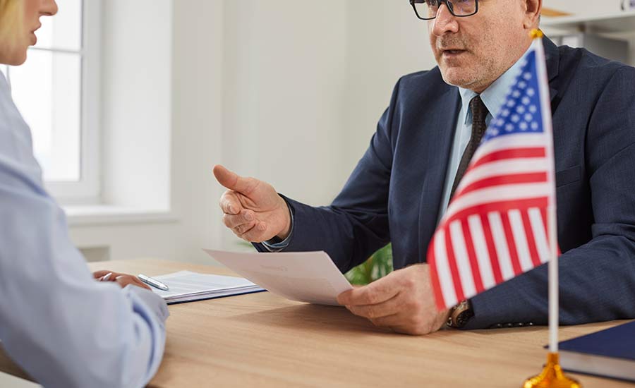 An officer conducting a naturalization interview​