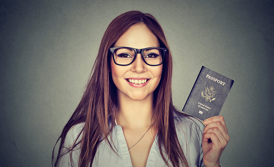 A smiling woman with a U.S. passport​