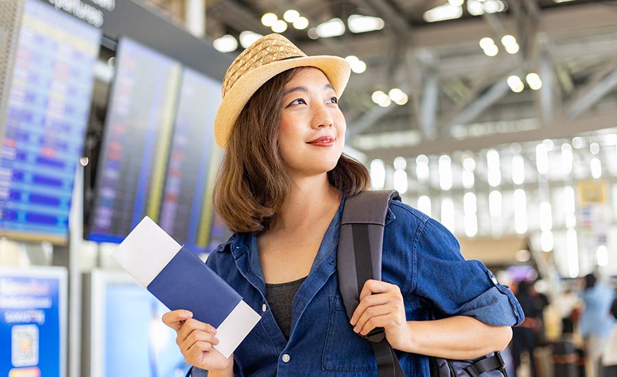 A young smiling woman at the airport​