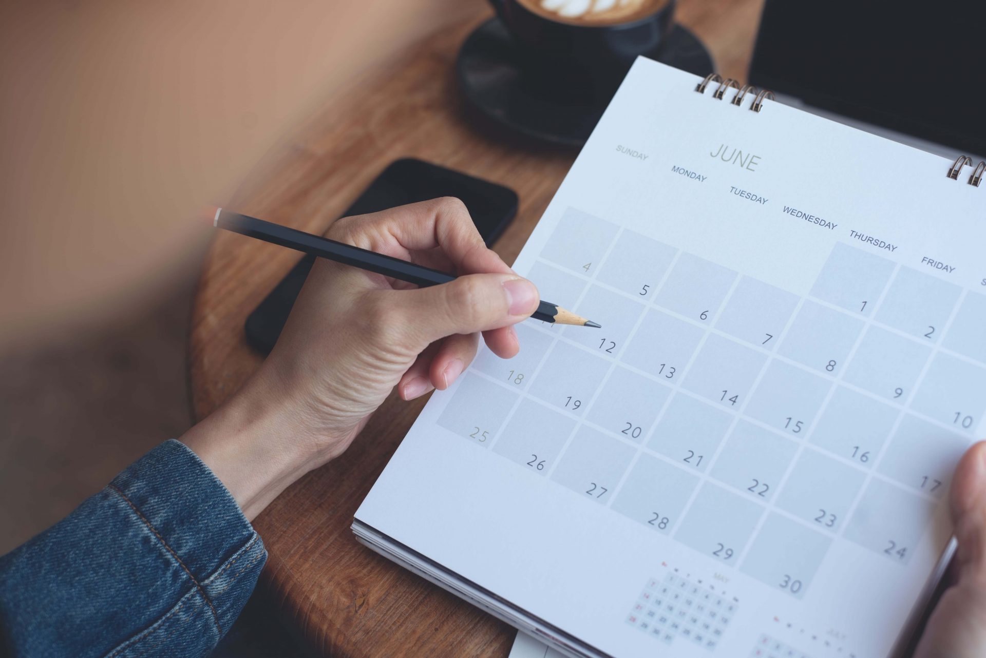 A person marking date in a planner