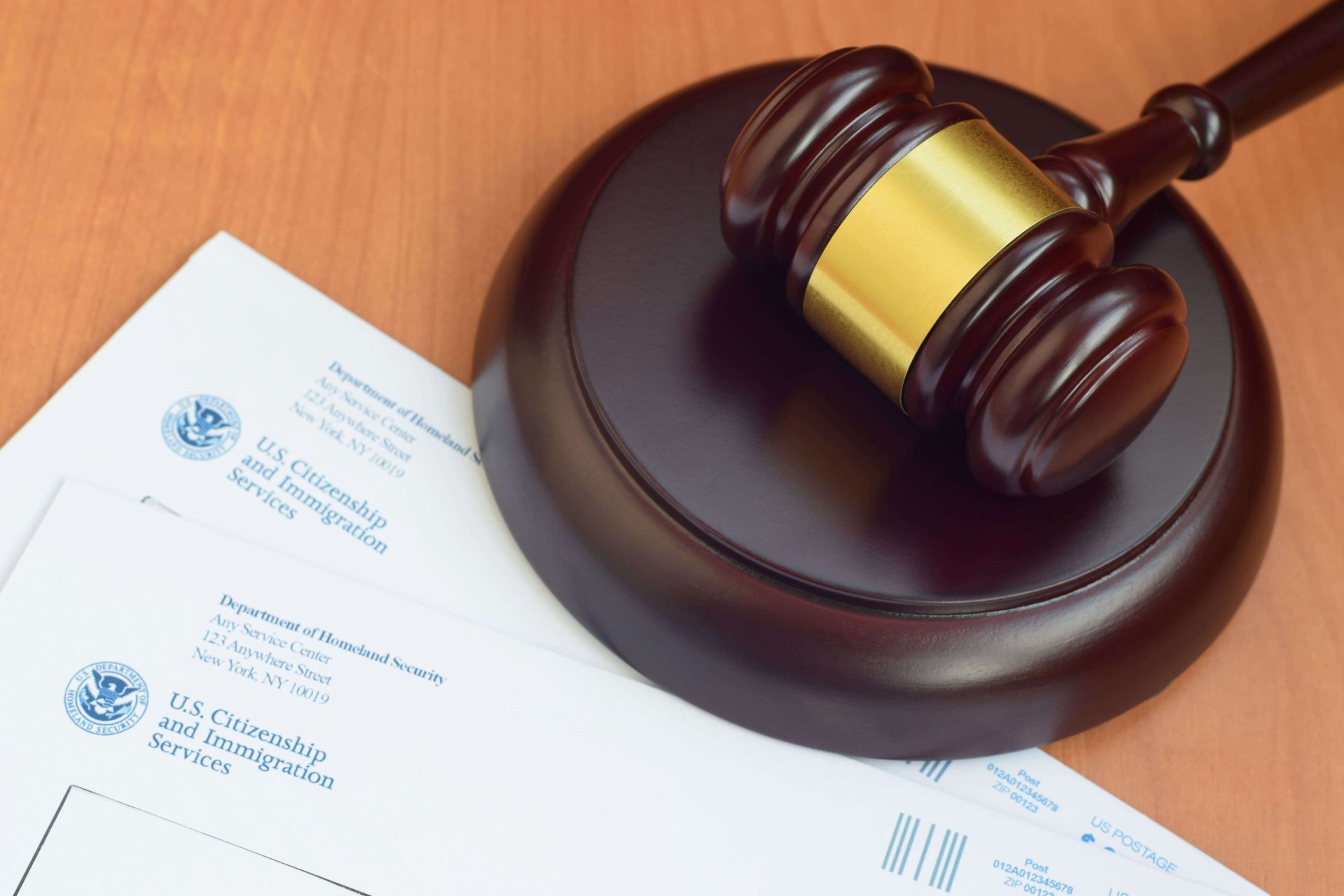 USCIS envelopes and a gavel