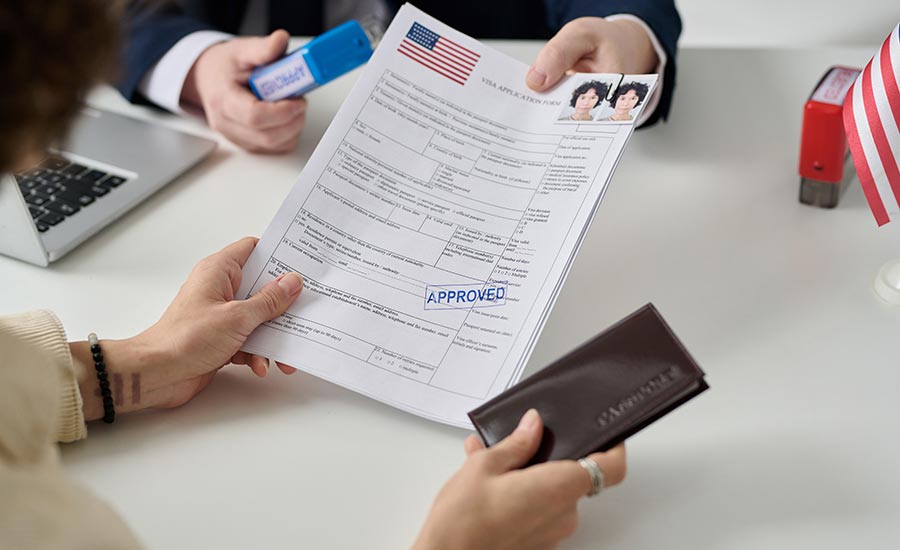 A woman holding immigration forms​