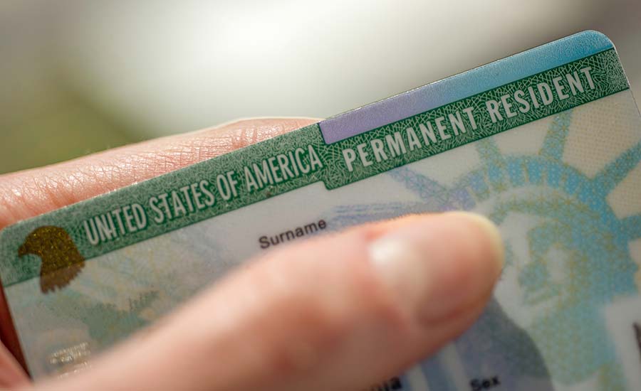 A person's hand with a Green Card​