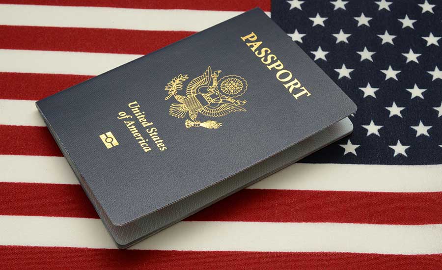 A U.S passport and the American flag​