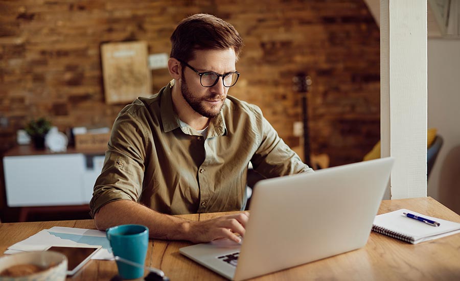 A man in front of a laptop​