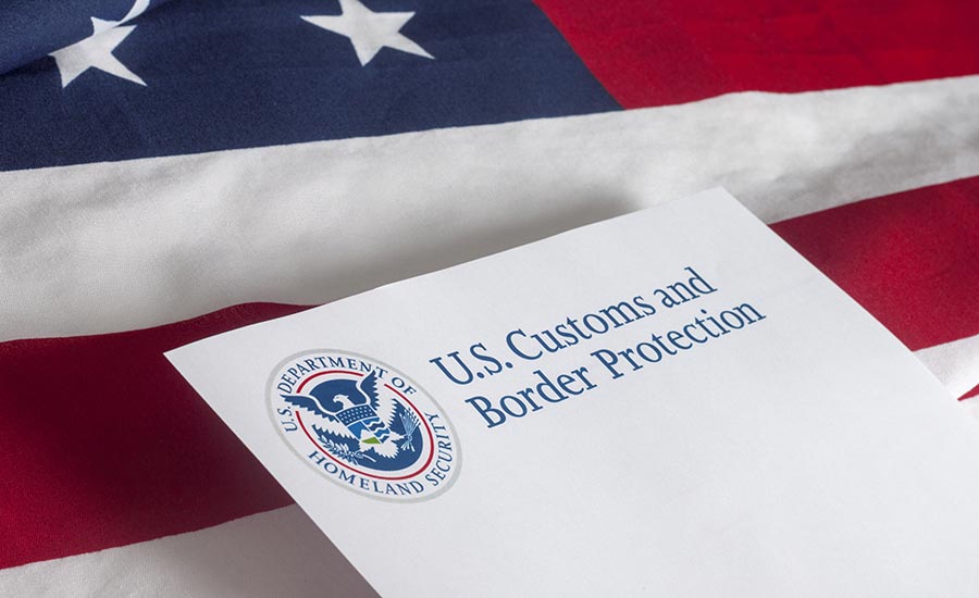 The U.S. flag and an envelope saying US Customs and Border Protection​