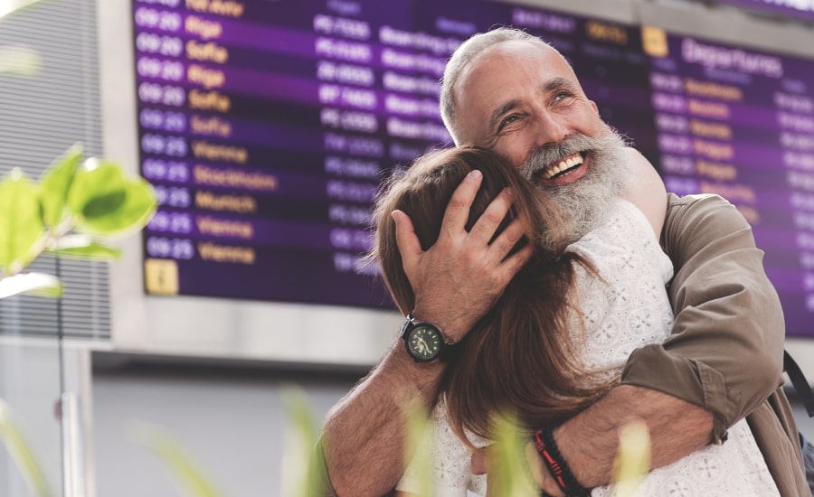 A man meeting his daughter at the airport