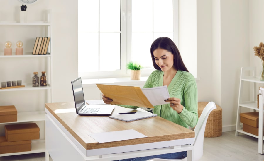 A woman collecting documents at her desk​