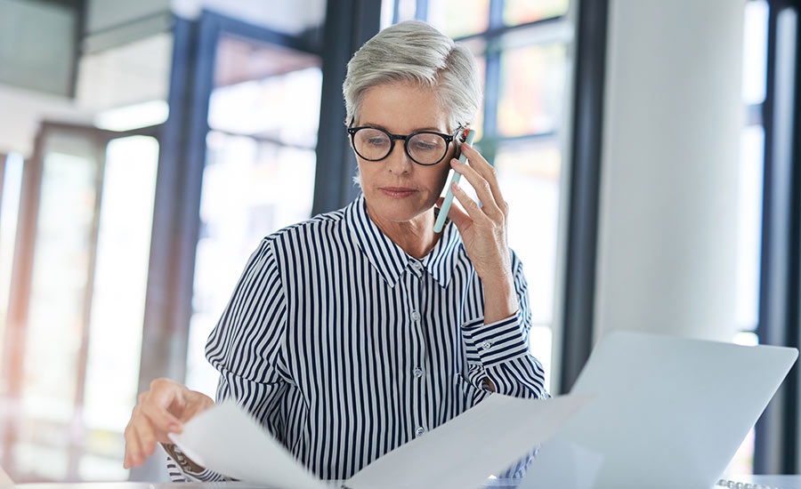 A beautiful middle-aged woman working in an office​