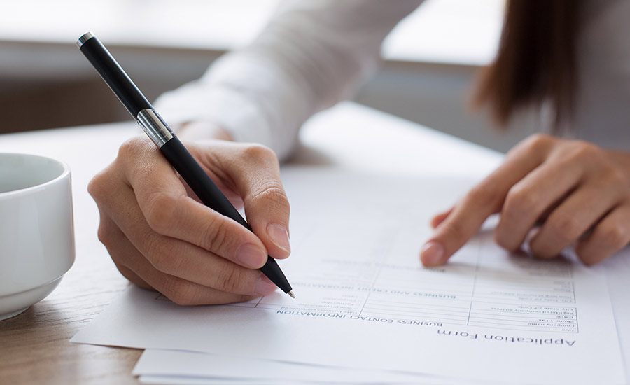 Closeup of Woman Completing Application Form