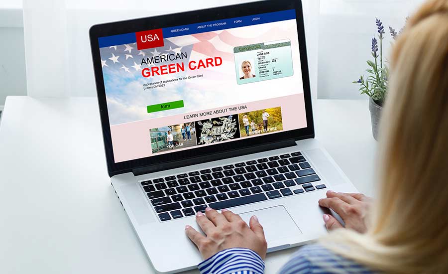 A woman looking at a Green card website on a laptop screen