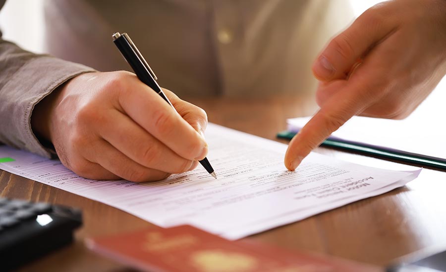 A person filling out immigration documents